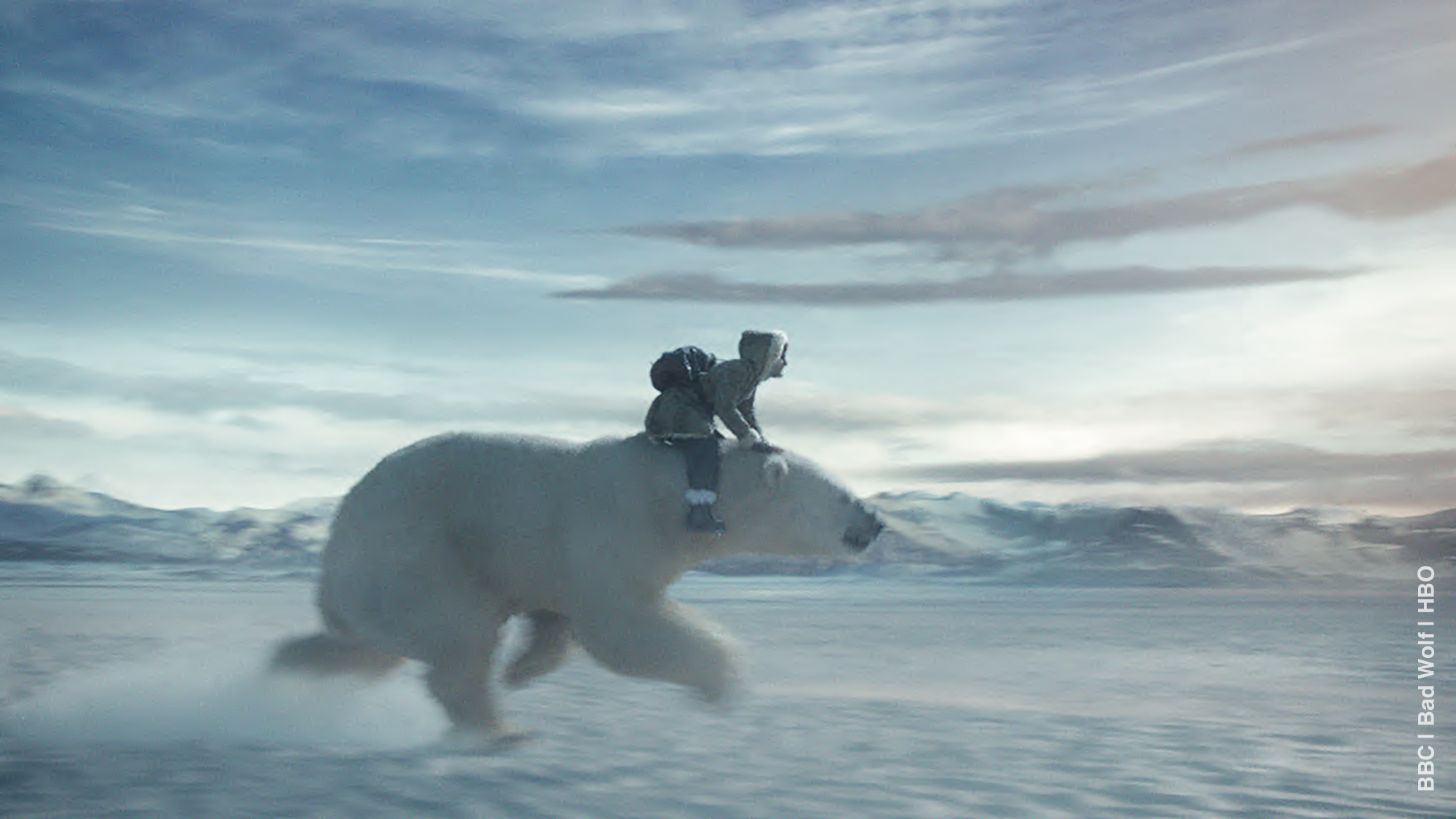 a girl rides on giant white bear in an icy landscape