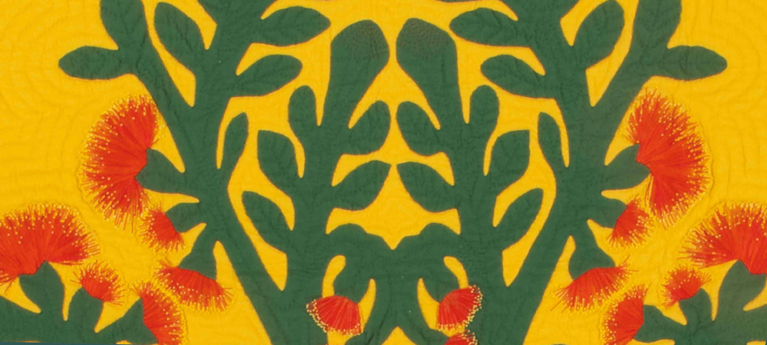 Detail of a quilt with green leaf motifs, red flowers made of thread, stitched with contoured lines on a yellow background