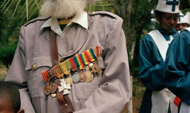 A veteran of the Imperial Guard pays his final respects. Addis Ababa, Ethiopia. Photograph by Peter Marlow. 2000.