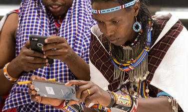 Maasai group looking at artefacts