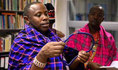 Maasai group looking at artefacts 