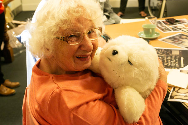 Smiling woman with seal plush toy