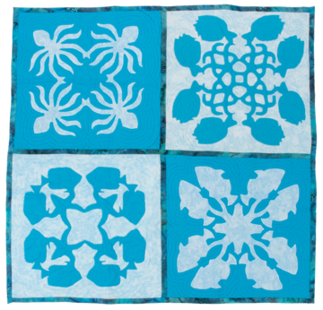 Blue and white quilt four sections appliqued with different aquatic animals. 
