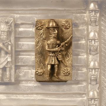 A small replica bronze plaque depicting a solider