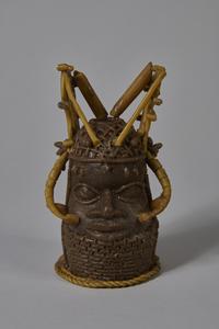 Figurine of a head with ornate jewellery/regalia, made of beeswax
