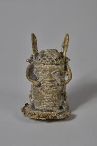 A rough bronze head with ornamentation