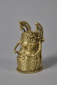 A polished bronze figure of a head, with intricate ornaments/jewellery